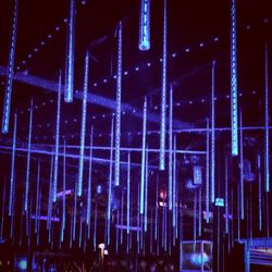 Close-up of illuminated lights against sky at night