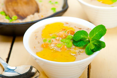 Hearty middle eastern chickpea and barley soup with mint leaves on top