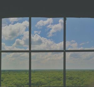 Scenic view of field against cloudy sky