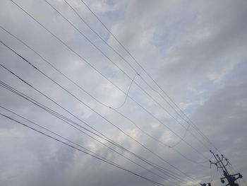 Low angle view of cables against sky