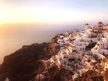 High angle view of townscape by sea against sky