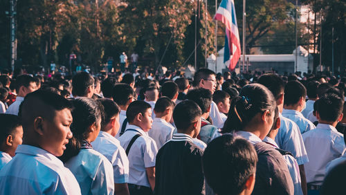 Rear view of people standing in city