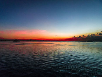 Scenic view of sea against clear sky during sunset