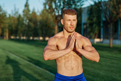 Portrait of shirtless man standing outdoors