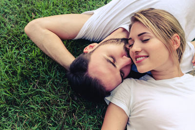 Young couple lying on grass