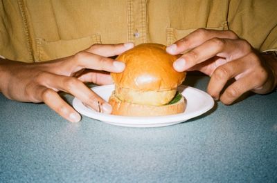 Midsection of man holding ice cream in plate