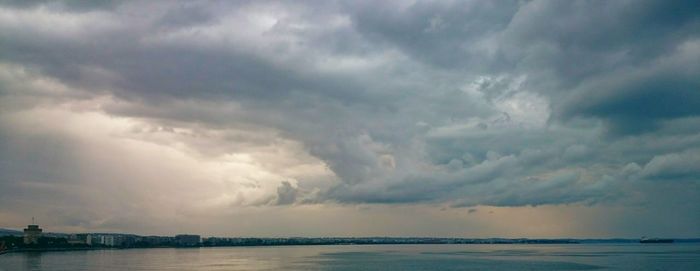 Scenic view of sea against storm clouds