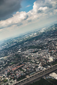 High angle view of townscape by sea against sky