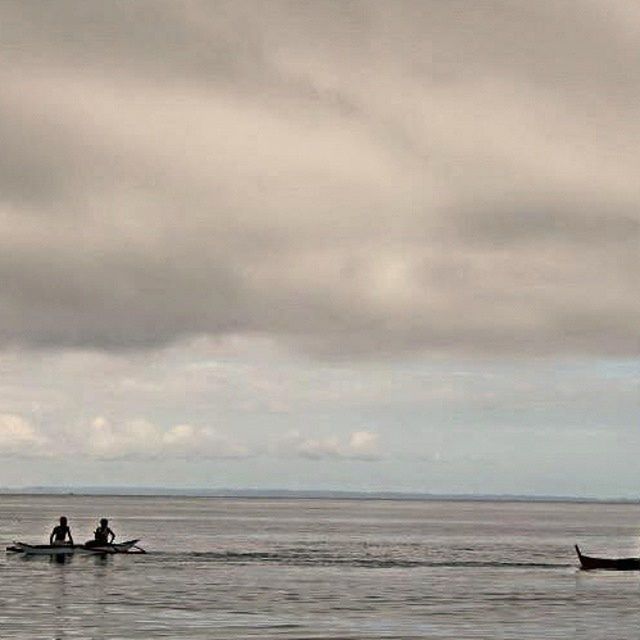 sea, water, horizon over water, sky, cloud - sky, transportation, nautical vessel, tranquility, cloudy, mode of transport, silhouette, scenics, beauty in nature, tranquil scene, nature, men, boat, beach, overcast