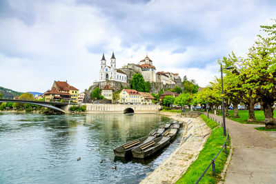 Bridge over river against buildings