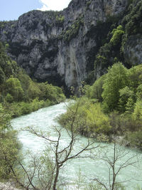 Scenic view of river amidst mountains