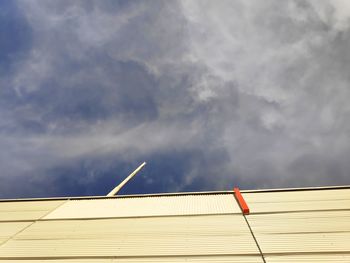 Low angle view of building against cloudy sky