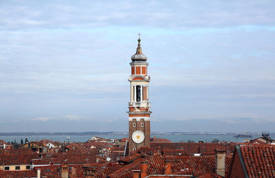 Tower amidst buildings in city against sky