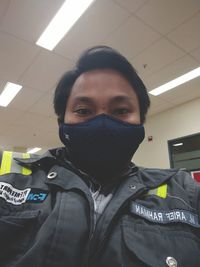 Portrait of young man covering face