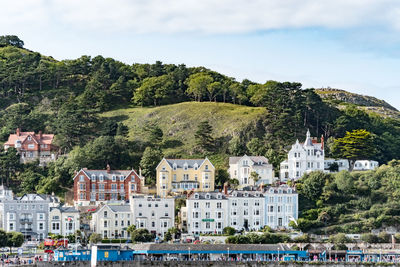 View of buildings in sea against cloudy sky