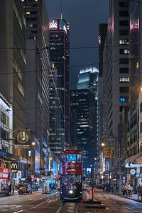 Illuminated city street and buildings at night