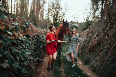 Women standing by people in forest