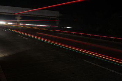 Light trails on road in city at night