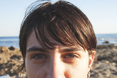 Close-up portrait of woman against clear sky