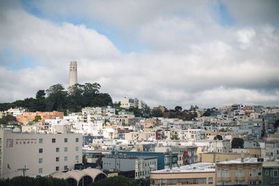 Buildings against cloudy sky