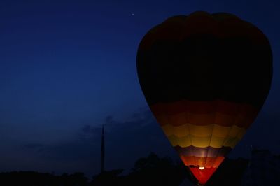 Hot air balloon against sky at night