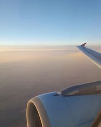 Cropped image of airplane flying over landscape