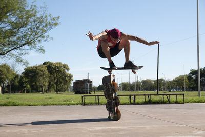 Low angle view of man jumping on road