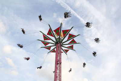 Low angle view of chain swing ride against sky