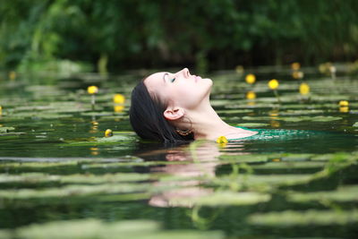 Portrait of woman swimming in lake