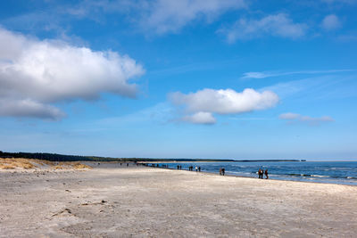 Scenic view of beach against blue sky