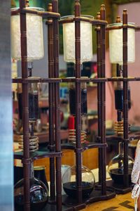 Close-up of wine bottles on rack in building