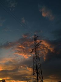 Low angle view of silhouette electricity pylon against sky during sunset