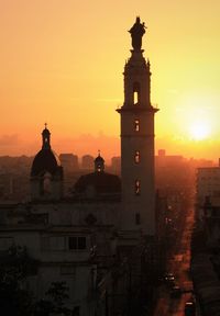 Silhouette of clock tower in city