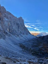 Scenic view of rocky mountains against blue sky