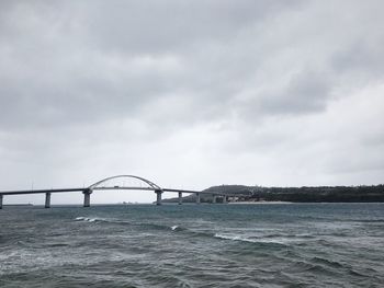 Bridge over sea against sky