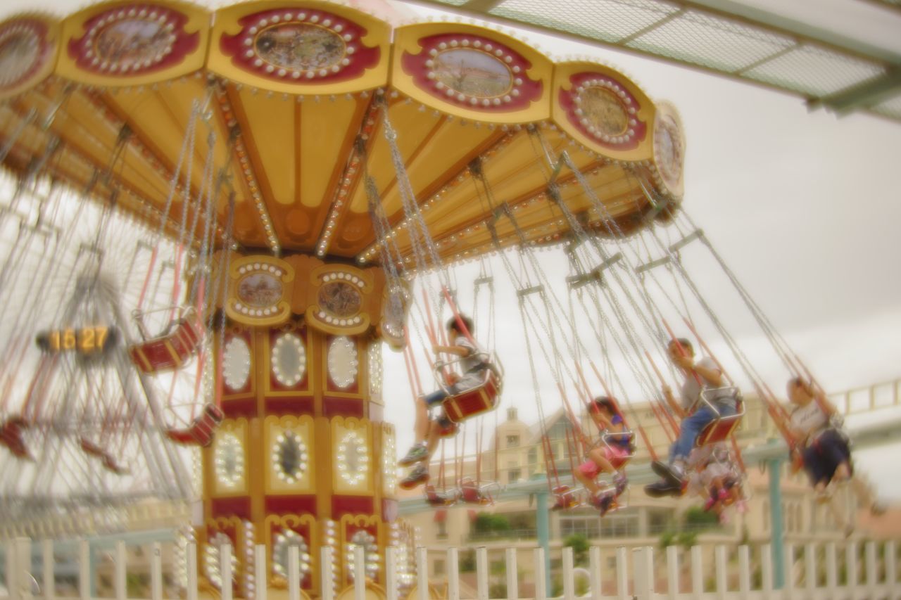 human representation, art and craft, indoors, art, close-up, carousel, selective focus, retail, creativity, collection, person, multi colored, amusement park, chain swing ride