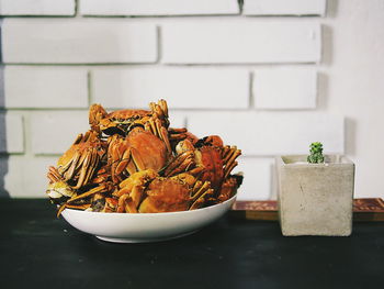 Close-up of crabs in plate on marble