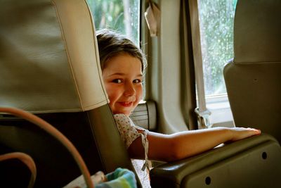 Cute girl sitting in the interior of a vehicle