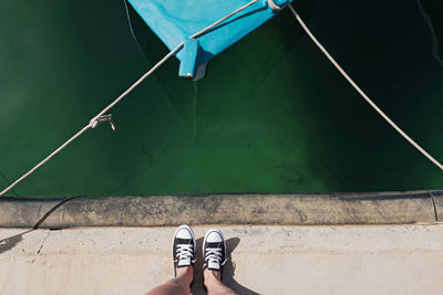 Low section of man standing on pier