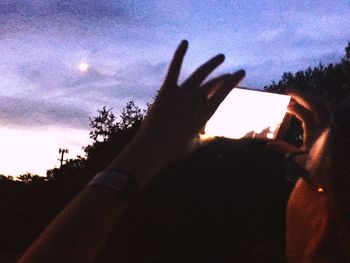 Silhouette of man standing against sky at sunset