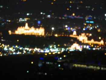 Defocused image of illuminated city at night