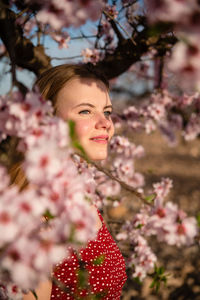 Portrait of woman with pink cherry blossom