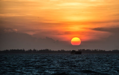 Scenic view of sea against romantic sky at sunset