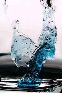 Close-up of water splashing on glass