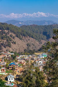 High angle view of townscape and mountains against sky