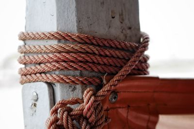 Close-up of rope tied on wooden post