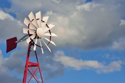 Low angle view of traditional windmill against sky