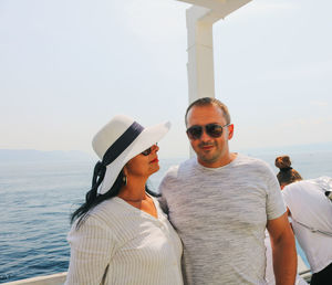 Friends enjoying in sea against sky