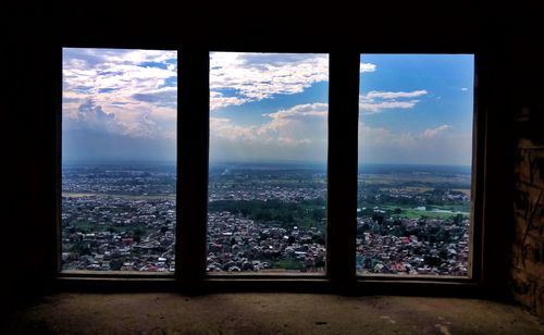 View of cityscape through window