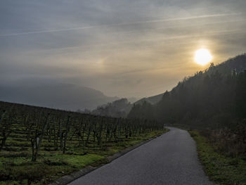 Scenic view of road against sky during sunset